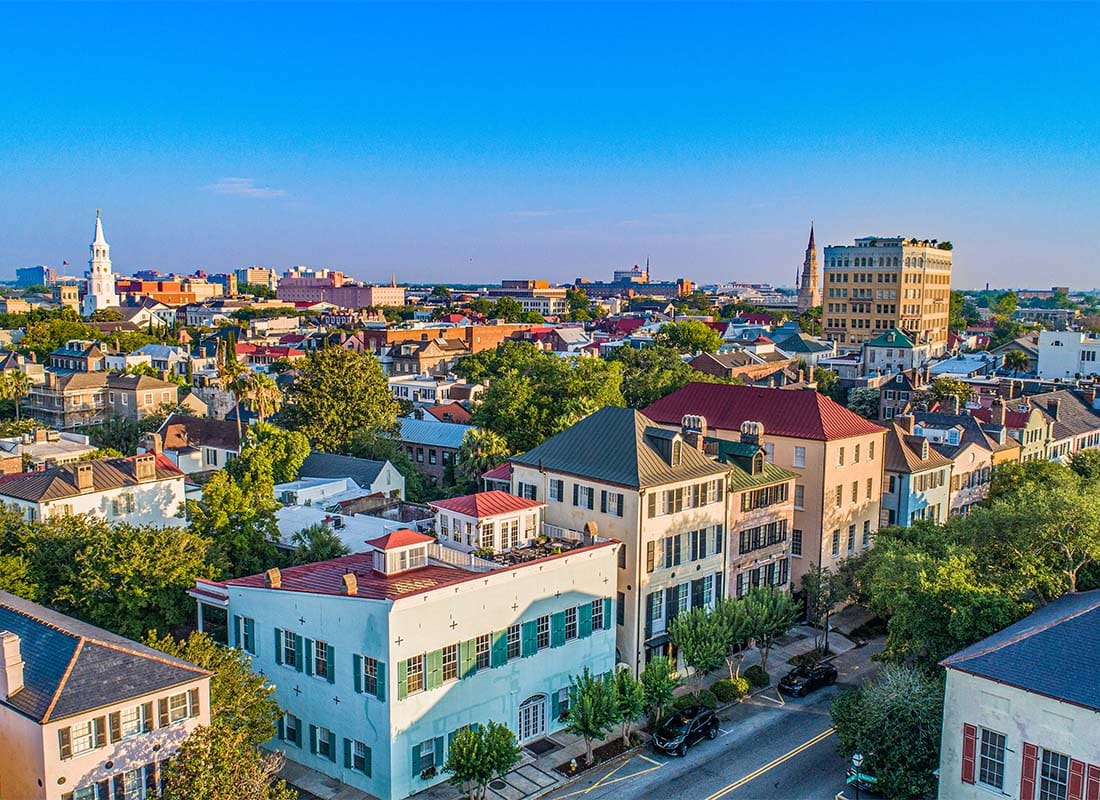 Charleston, SC - Aerial View of Commercial and Residential Buildings in Downtown Charleston South Carolina Against a Colorful Sunset Sky